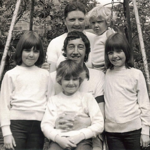 Enjoying the garden with his family in 1983.  Top row from left to right: Sylvia Flanner and Ian Flanner.  Middle row from left to right: Sara Flanner, John Flanner MBE, and Allison Flanner. Front row: Beverley Flanner.